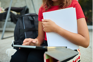 School girl uses tablet while, a School & Education Photo by IlliaBondarPhotography