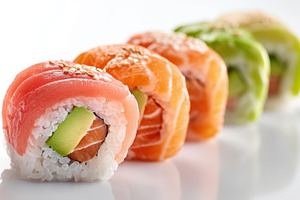 Colorful assortment of sushi rolls on white background, a Food & Drink Photo by AlyaAnd