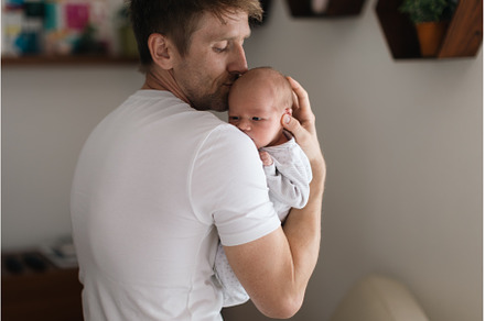 Father holding his newborn son at, a Person Photo by HalfPoint