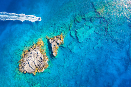Aerial view of beautiful speed boat on the sea at sunset, a Nature Photo by den-belitsky