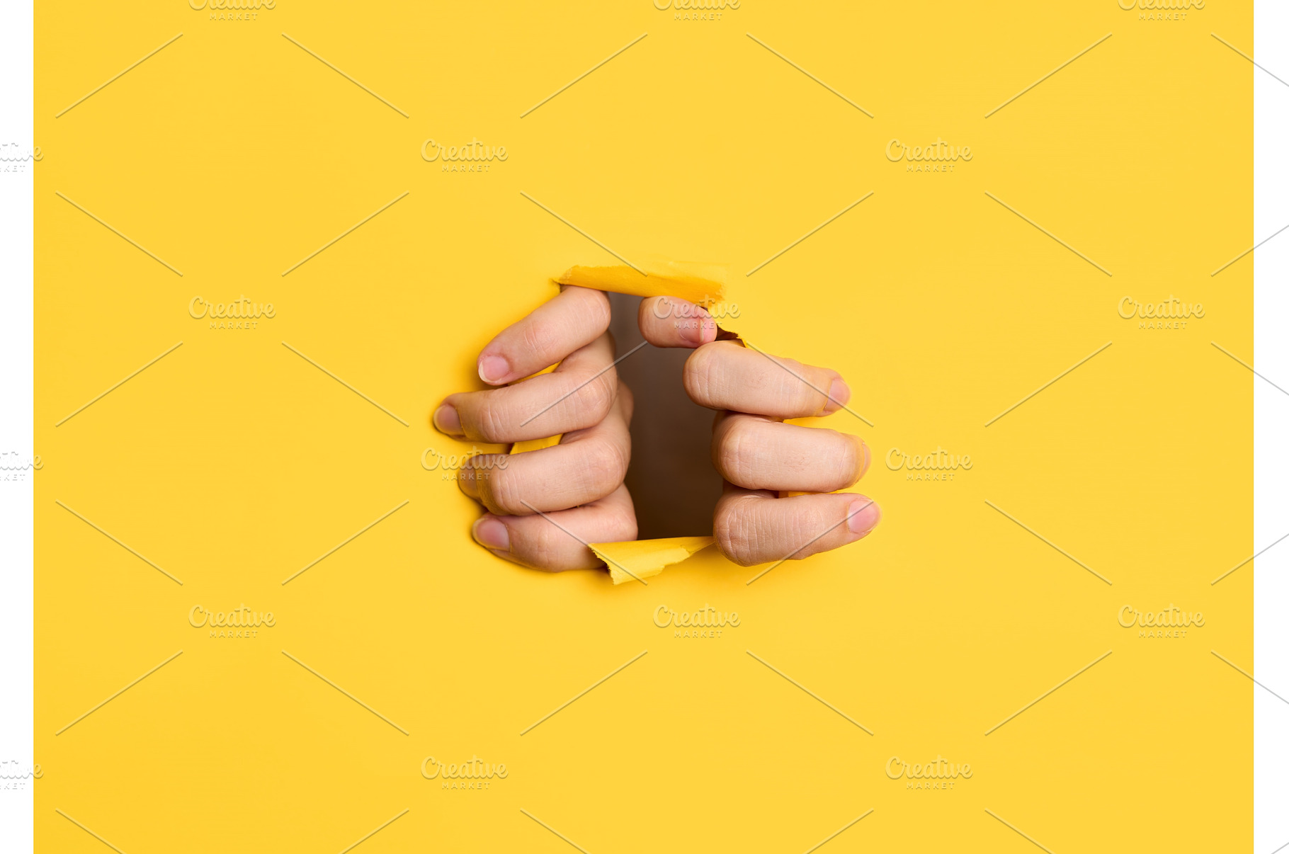 Human hands tearing yellow paper, an Abstract Photo by Gladkov photography