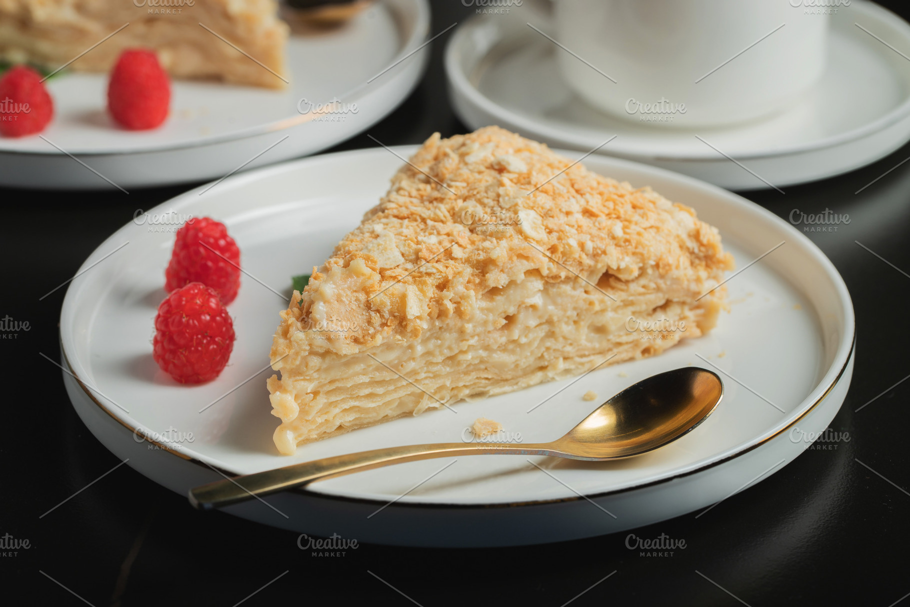 Sliced Napoleon cake on a white wooden table. Classic dessert, a Food & Drink Photo by Budarinphoto