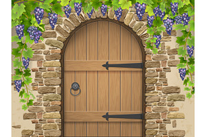 Arch of stone grapes and wooden door