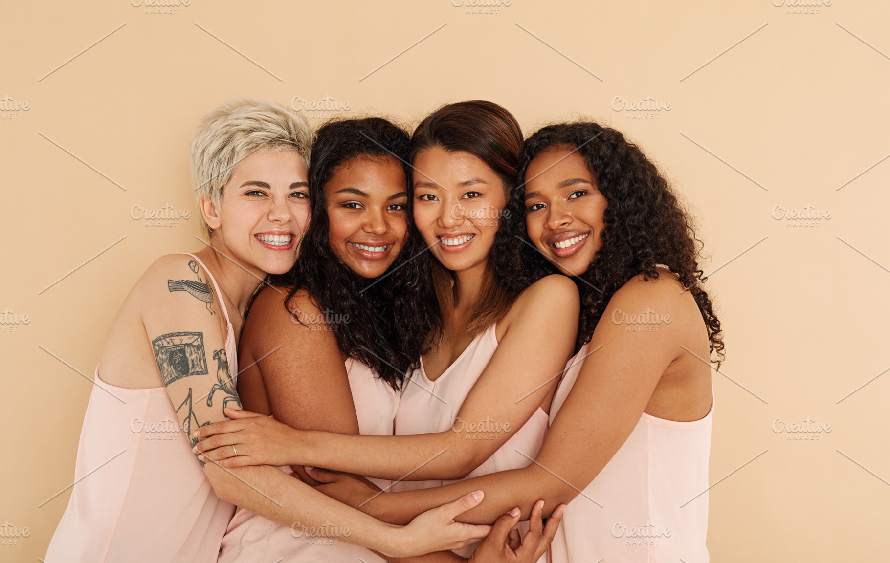Four young smiling females embracing, a Person Photo by Artem Varnitsin