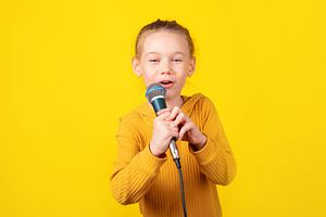 Child Singing with Microphone, a Person Photo by Ales Munt