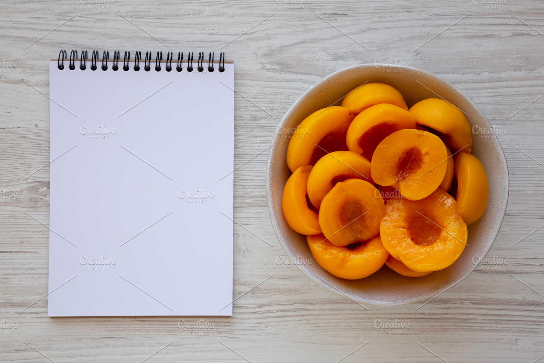 Healthy Organic Canned Peach Halves in a Bowl, blank notepad, to, a Food & Drink Photo by LiudmylaChuhunova