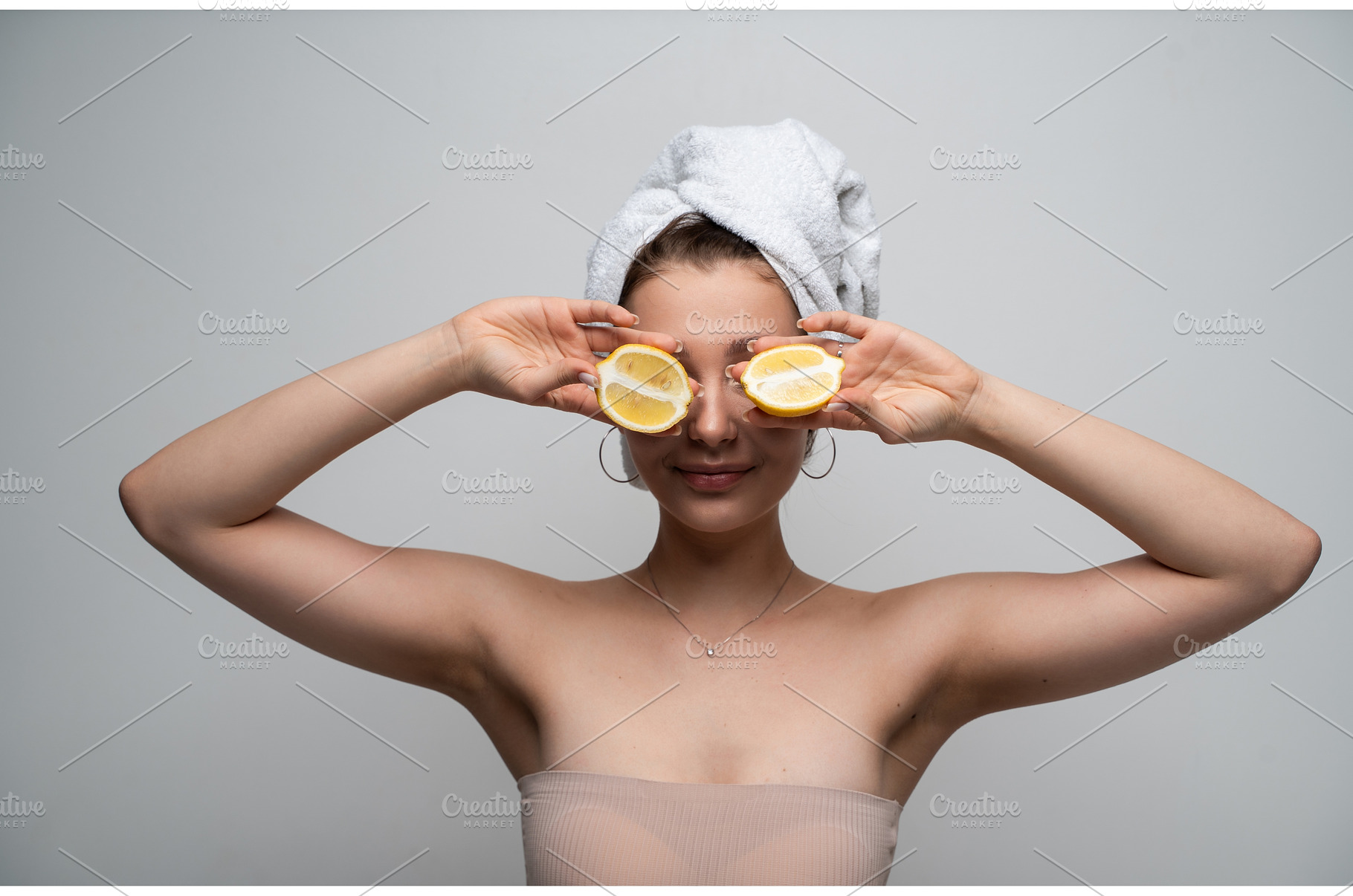 Woman with towel holding lemon, a Health & Medical Photo by volodymyrshtun13795