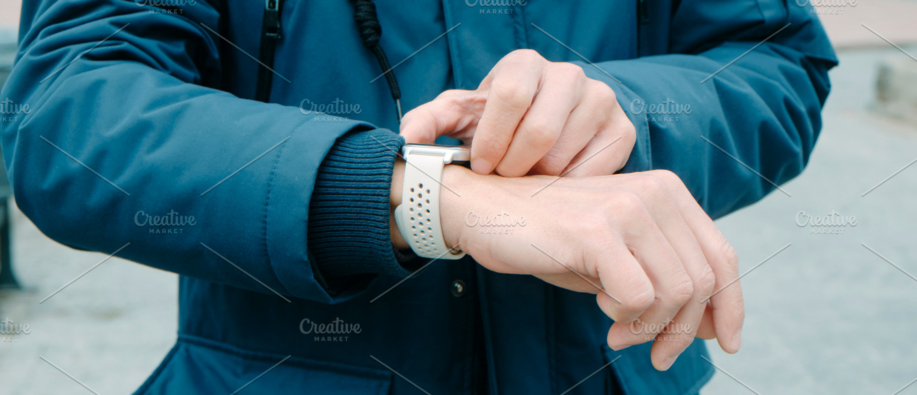 man activates his smartwatch, banner format, a Photo by Nito