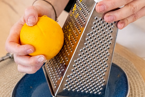 Culinary process zest grating chef hand orange, a Person Photo by Photo Drive Studio