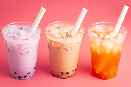 Three Different Types of Boba Tea on a Bright Pink Background