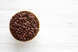 Organic Roasted Coffee Beans in a Bowl, top view. Copy space., a Food & Drink Photo by LiudmylaChuhunova
