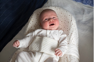 baby in cocoon looking up on her, a Person Photo by Koldunova