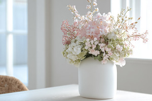 Pink and white flowers blooming in a vase, creating a serene and, a Photo by Studio ANNA