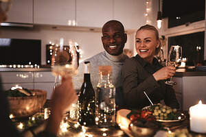 Smiling couple talking with friends