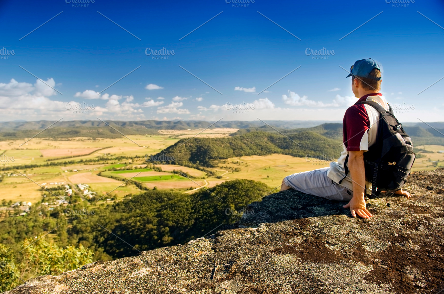 Man Sitting on Ledge With View, a Person Photo by THP Creative