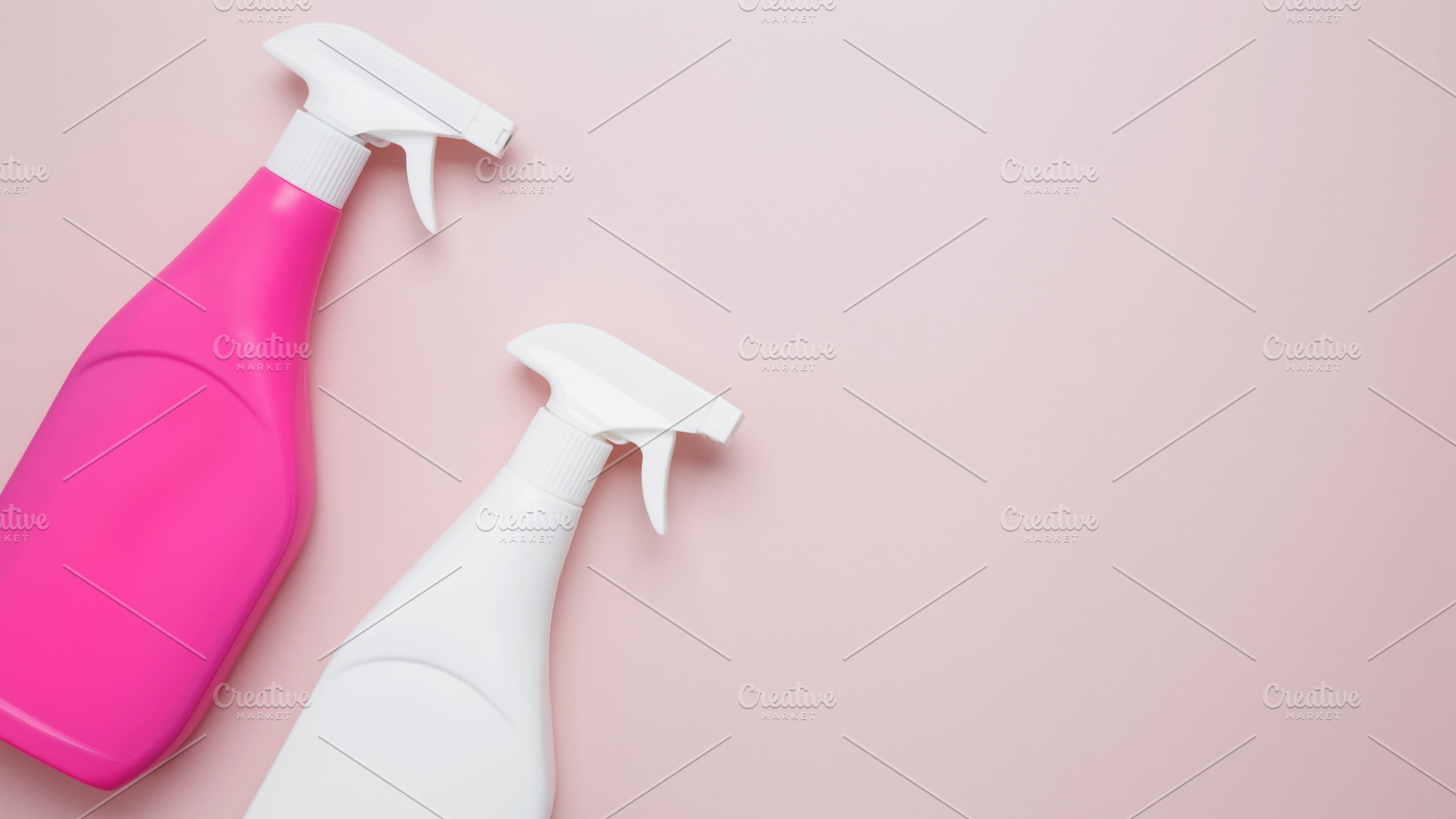 Household cleaning and hygiene concept. Pink and white cleaning supplies spray, a Photo by matucha