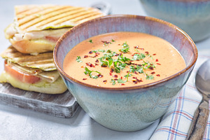 Red bell pepper cream soup with grilled turkey panini, horizontal, a Food & Drink Photo by iuliia_n