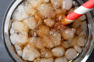 Detail of glass with refreshing drink with ice top view, a Food & Drink Photo by Davizro's Market