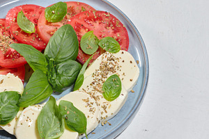 Classic Caprese salad with sliced fresh tomatoes, mozzarel, a Food & Drink Photo by ndanko