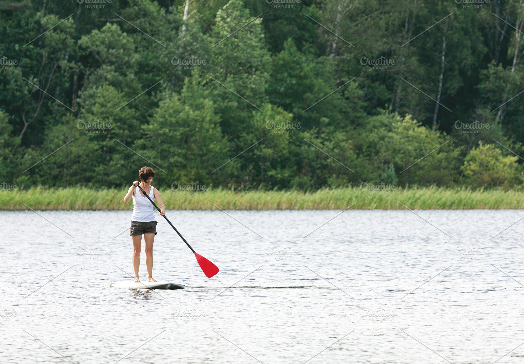 Woman on SUP paddle board, a Sports & Recreation Photo by BOOCYS