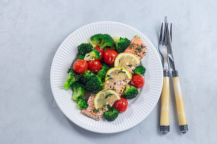 Salmon steak with vegetables, baked salmon fillet with broccoli and tomato, hor, a Food & Drink Photo by iuliia_n