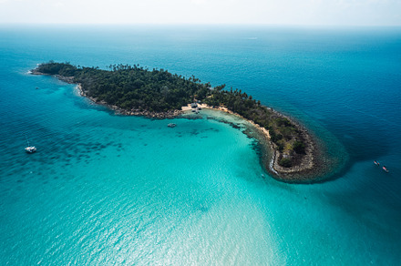 Tropical island from above and clear blue sea, a Nature Photo by Art Rachen