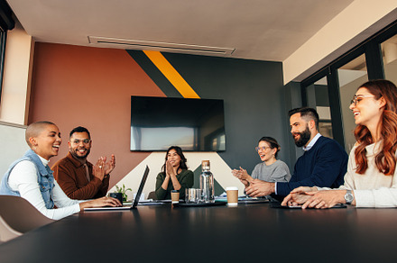 Successful businesspeople applauding their colleague, a Person Photo by Jacob Lund