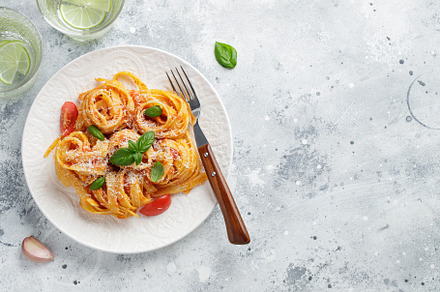 Tasty appetizing classic italian tagliatelle pasta with tomato sauce, cheese pa, a Food & Drink Photo by Budarinphoto