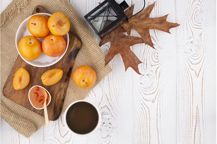 Plum jam in a bowl and yellow plums