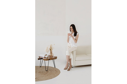 Attractive woman in white using, a Person Photo by Aliona Serzhanova