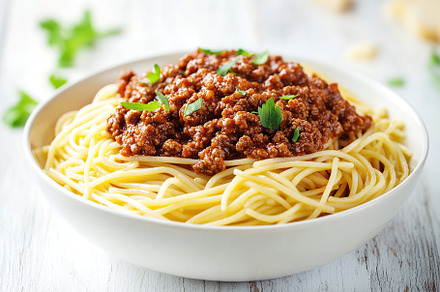 Spaghetti bolognese with ground beef in plate, a Food & Drink Photo by AlyaAnd