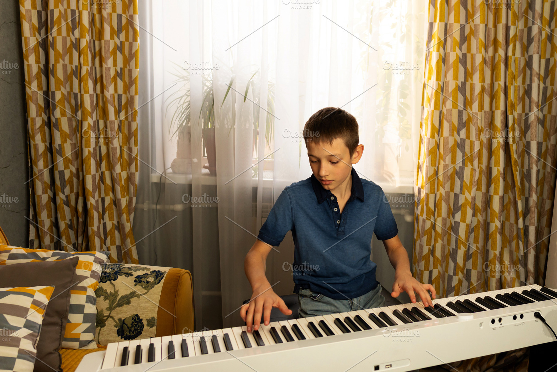 Teen boy in blue polo shirt playing, a Person Photo by Elena Vagengeim