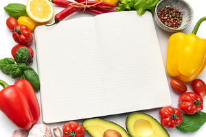 Open recipe book surrounded by fresh vegetables ingredients, a Food & Drink Photo by Olena Rudo