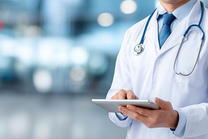 Male doctor in white coat use tablet, a Health & Medical Photo by MistyDay