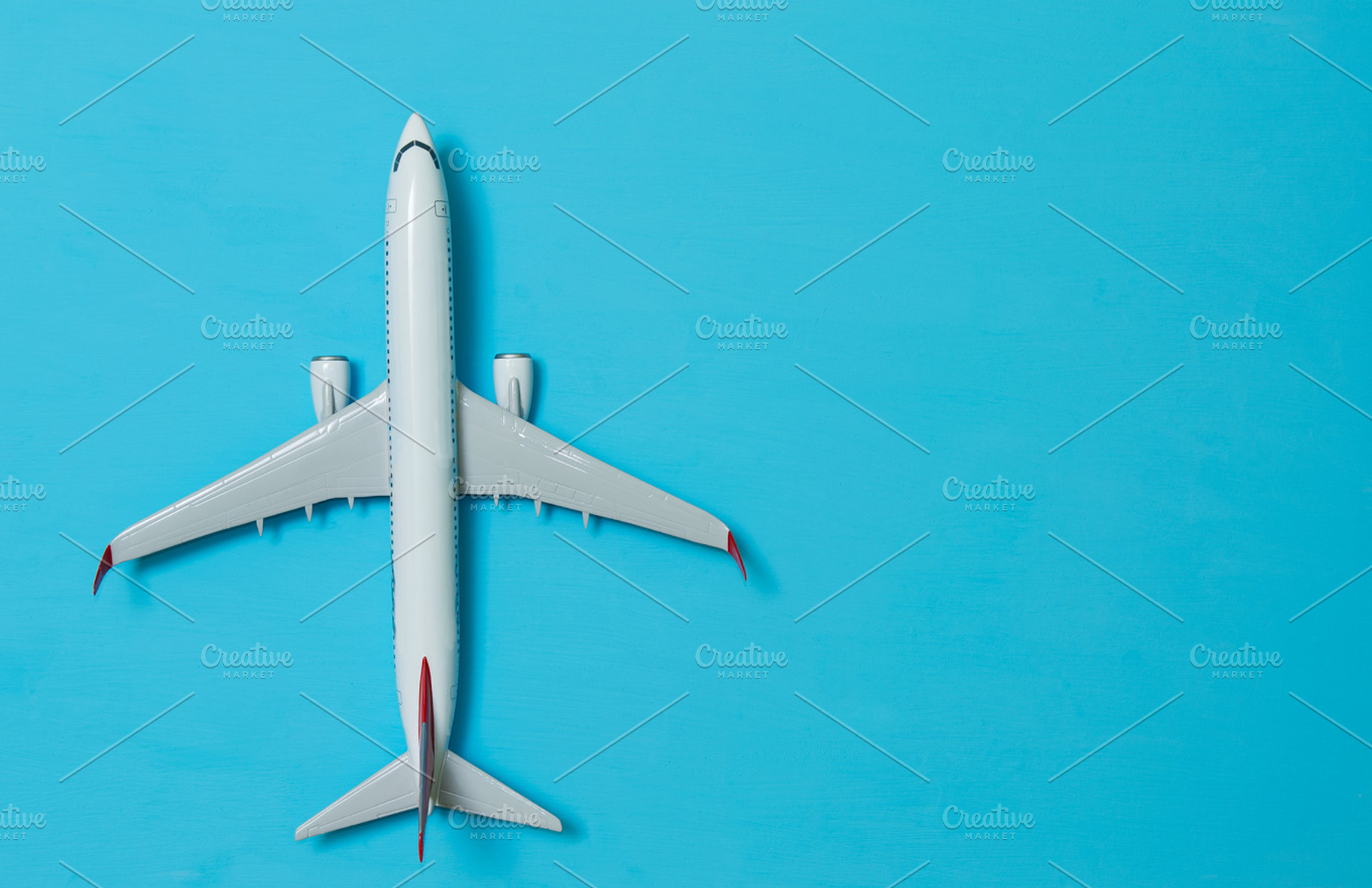 white airplane on a blue, a Background Photo by badahos