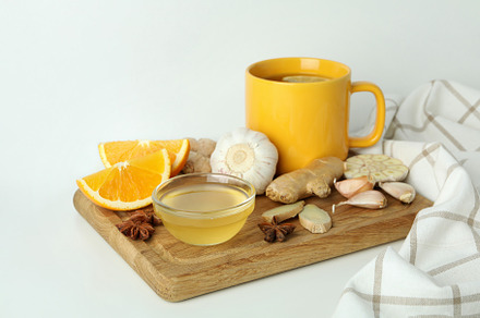 Concept of treatment colds with honey and garlic on white backgr, a Health & Medical Photo by AtlasStudio PRO