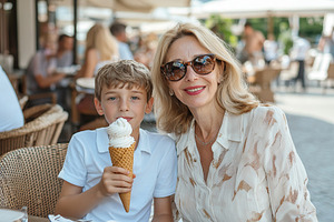 A joyful grandmother and her grandson share ice cream cones outdoors, smiling., a Person Photo by AlyaAnd