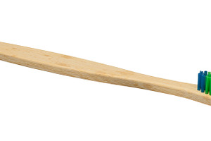 Bamboo toothbrush with bright multi-colored bristles isolated on, a Health & Medical Photo by ndanko
