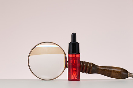 red glass bottle with pipette for cosmetics, oils and serum. Adv, a Beauty & Fashion Photo by ndanko