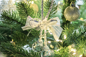 Christmas tree decorating with shimmering silver ornaments and l, a Holiday Photo by Olena Rudo