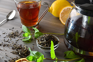 Black tea infusion on a wooden table with ingredients, a Food & Drink Photo by Davizro's Market