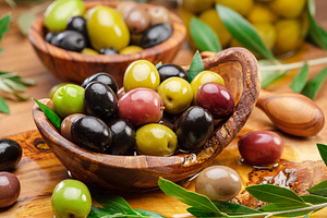 Kalamata, green and black olives in the wooden bowl. Food backgr, a Food & Drink Photo by Volff