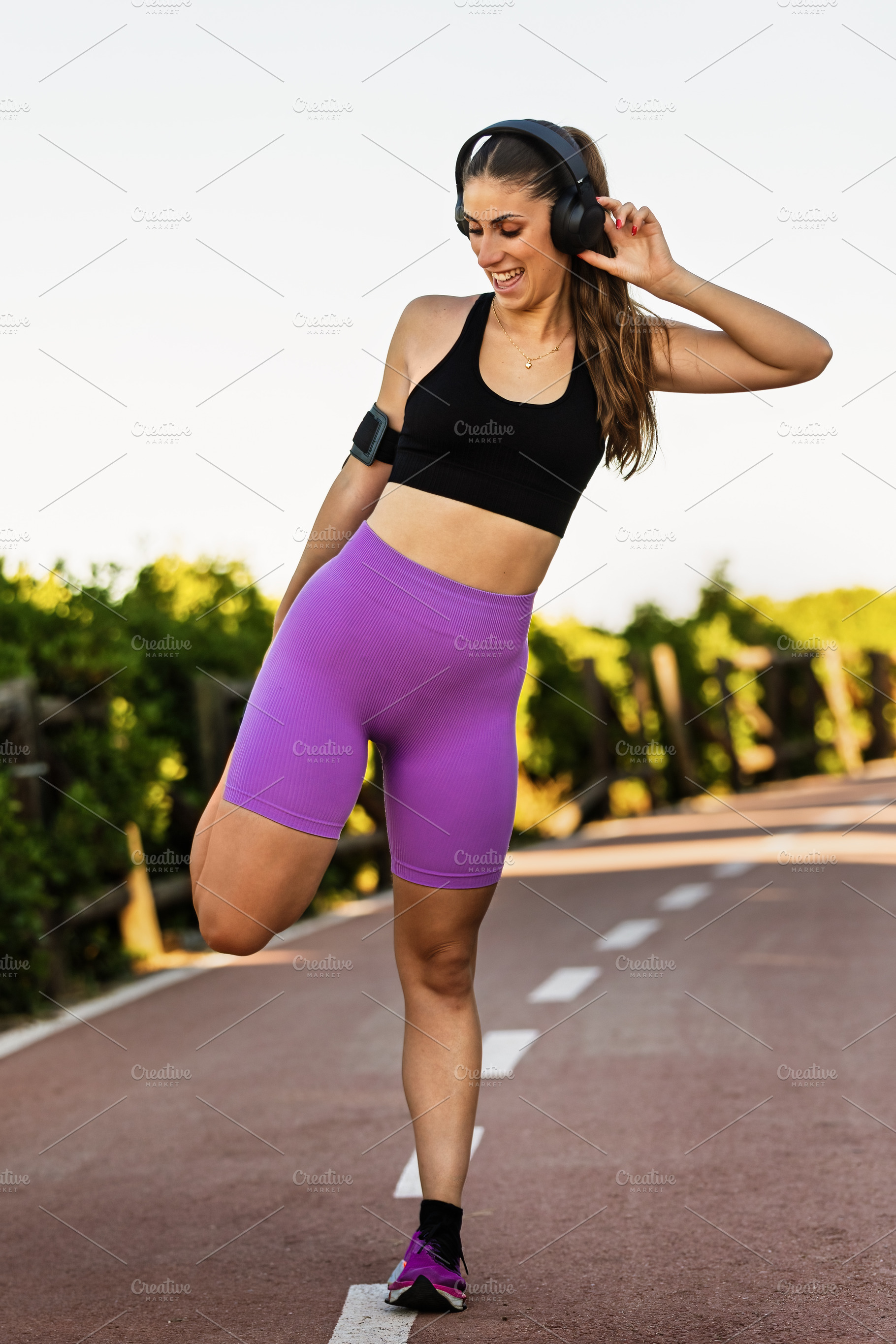 Young woman stretching and listening, a Sports & Recreation Photo by Perpis