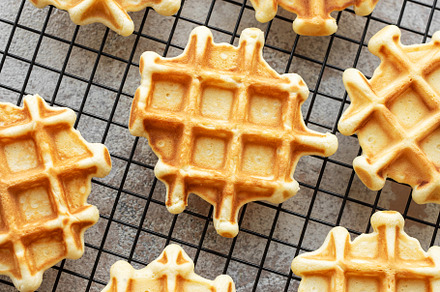 Freshly baked waffles on a baking rack., a Food & Drink Photo by Olena Rudo