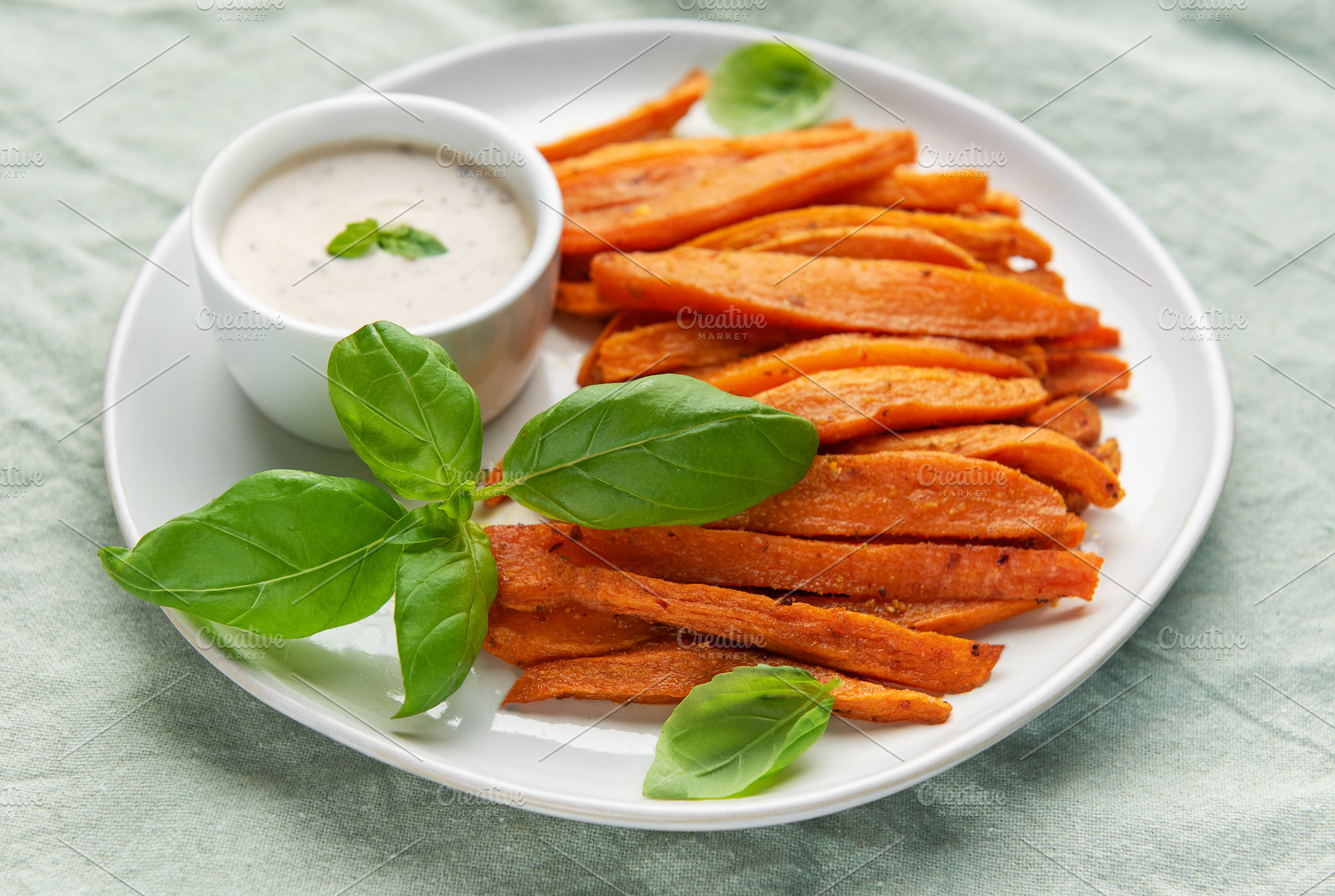Sweet potato fries with dipping sauce and basil, a Food & Drink Photo by Olena Rudo