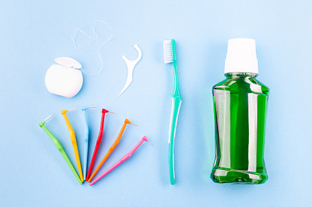 Dental floss, toothbrush, interdental brush angles and mouthwash on blue, a Health & Medical Photo by iuliia_n