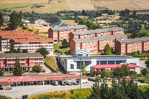 Tineo residential area with parking, an Architecture Photo by SkyNext