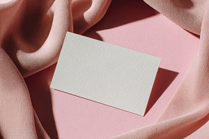 Blank card on pink fabric surface, a Photo by Beautiful things