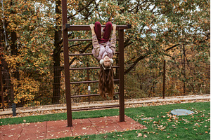 Girl hanging upside down on, a Nature Photo by HalfPoint