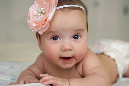 Baby girl lying on the bed containing baby, girl, and diaper, a Person Photo by SaulichPhoto